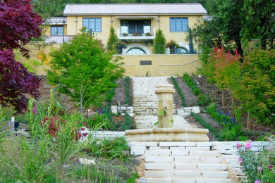Large yellow two-story stucco gable roof idea in Seattle