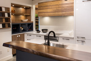 Photo of a small modern galley eat-in kitchen in Vancouver with a drop-in sink, flat-panel cabinets, white cabinets, concrete benchtops, white splashback, ceramic splashback, panelled appliances, concrete floors and with island.