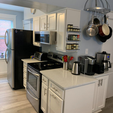 cabinet refacing---white cabinets with white quartz and glazed backsplash