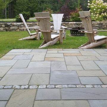 An extensive landscape project with stonewalls, patio, dry river bed & more