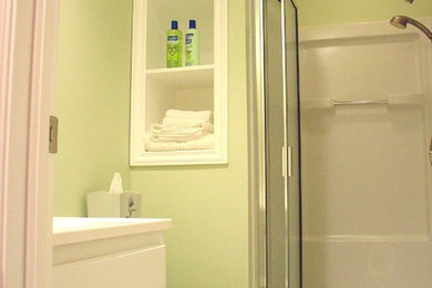 Bathroom - small contemporary 3/4 white tile and ceramic tile ceramic tile bathroom idea in Columbus with an integrated sink, raised-panel cabinets, white cabinets, marble countertops, a two-piece toilet and green walls