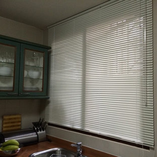 Industrial kitchen pantry ideas - Example of an urban kitchen pantry design in Singapore with glass-front cabinets and green cabinets