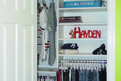 Mid-sized elegant gender-neutral ceramic tile and brown floor reach-in closet photo in Atlanta with open cabinets and white cabinets