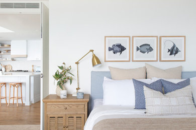 Design ideas for a mid-sized beach style guest bedroom in Gold Coast - Tweed with white walls, carpet and beige floor.