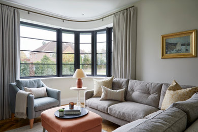 Design ideas for a medium sized classic formal enclosed living room curtain in West Midlands with beige walls, a standard fireplace, a stone fireplace surround and a corner tv.