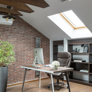 Inspiration for a mid-sized contemporary study room in Moscow with brown walls, medium hardwood floors, a freestanding desk and brown floor.