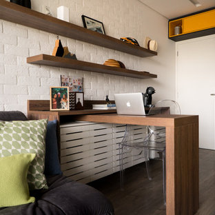 Inspiration for a small modern home office and library in Other with a reading nook, white walls, vinyl flooring, a built-in desk and grey floors.