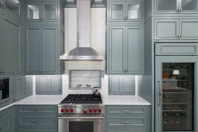 Large transitional u-shaped porcelain tile open concept kitchen photo in Dallas with an undermount sink, raised-panel cabinets, white cabinets, marble countertops, white backsplash, ceramic backsplash, paneled appliances and an island