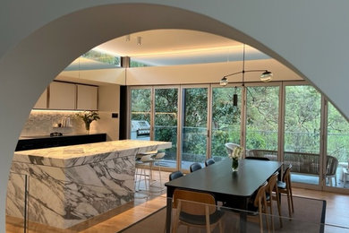 Photo of a large eclectic kitchen/dining combo in Sydney with light hardwood floors.