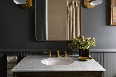 This is an example of a traditional bathroom in Seattle with distressed cabinets, grey walls, an undermount sink, white benchtops and flat-panel cabinets.