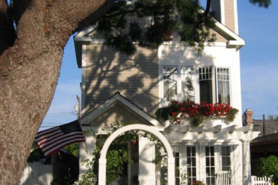 Example of a small beach style beige two-story concrete fiberboard exterior home design in San Diego with a shingle roof