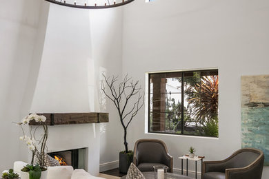 Inspiration for a mediterranean dark wood floor living room remodel in San Francisco with white walls and a plaster fireplace