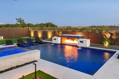 Large minimalist backyard concrete and custom-shaped pool landscaping photo in Phoenix