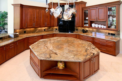 Inspiration for a large transitional u-shaped kitchen remodel in Miami with a double-bowl sink, raised-panel cabinets, medium tone wood cabinets, granite countertops, multicolored backsplash, stone slab backsplash, stainless steel appliances and an island