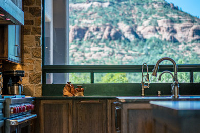 Inspiration for a transitional kitchen remodel with shaker cabinets, dark wood cabinets, paneled appliances and an island