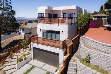 Contemporary white two-story stucco exterior home idea in San Francisco