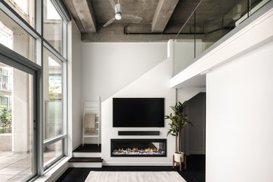 Living room - small modern loft-style dark wood floor, brown floor and exposed beam living room idea in Vancouver with white walls, a ribbon fireplace and a media wall