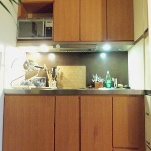 Small contemporary kitchen pantry pictures - Kitchen pantry - small contemporary single-wall medium tone wood floor kitchen pantry idea in Paris with an integrated sink, brown backsplash and cement tile backsplash