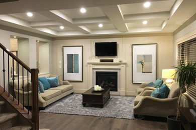 Inspiration for a mid-sized transitional enclosed and formal dark wood floor and brown floor living room remodel in Calgary with beige walls, a standard fireplace, a stone fireplace and a wall-mounted tv