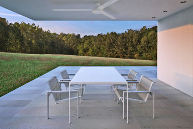 Example of a minimalist backyard stone patio design in San Francisco