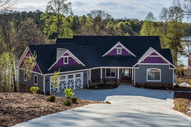 Large elegant gray two-story concrete fiberboard exterior home photo in Other