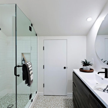 B&W Guest Bath with Tile Floor and Round Mirror