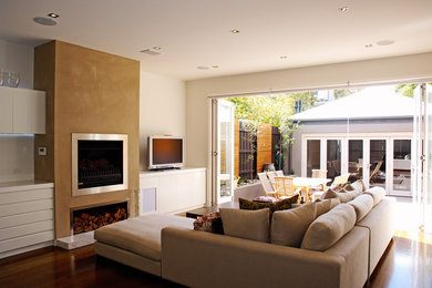 Large traditional open concept living room in Melbourne with medium hardwood floors, a standard fireplace, a metal fireplace surround and a freestanding tv.