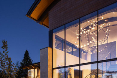 Inspiration for a contemporary two-story house exterior remodel in Other with a metal roof