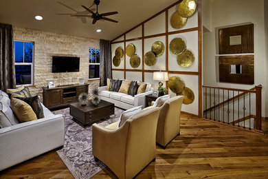 Transitional medium tone wood floor living room photo in Denver with a wall-mounted tv