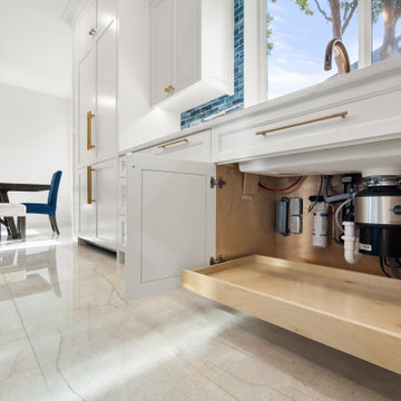 Open Cabinet Under Sink with InSinkErator Garbage Disposal and Pull-Out Tray