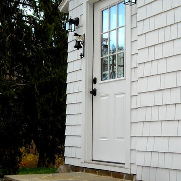 Antique Farmhouse Restoration - side entry with granite bench and original boot