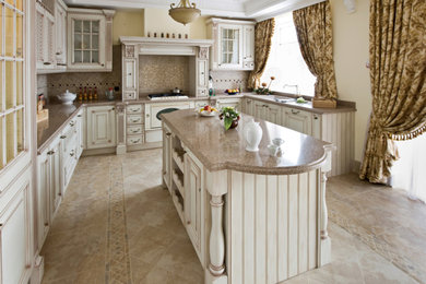 Photo of a traditional u-shaped eat-in kitchen in Philadelphia with an undermount sink, raised-panel cabinets, white cabinets, granite benchtops, beige splashback, stone tile splashback and stainless steel appliances.