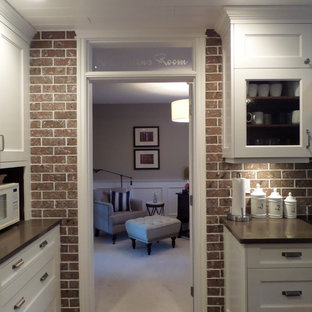 Inspiration for a small transitional study room in Vancouver with grey walls, carpet, a hanging fireplace and a freestanding desk.