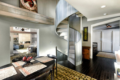 Mid-sized trendy wooden spiral metal railing staircase photo in Other with wooden risers