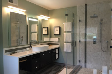 Large minimalist master multicolored tile and glass tile porcelain tile bathroom photo in Los Angeles with a vessel sink, flat-panel cabinets, brown cabinets, solid surface countertops, a one-piece toilet and green walls
