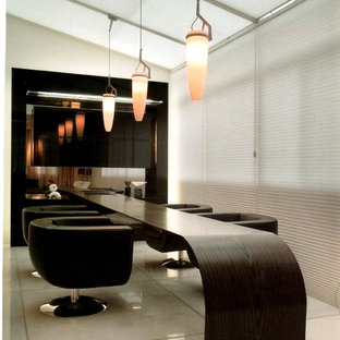 This is an example of a mid-sized contemporary study room in Los Angeles with beige walls, a built-in desk and marble floors.