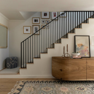 Staircase with Off-White Runner, Gallery Wall, and Styled Console Table