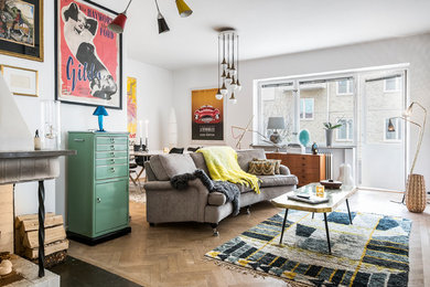 Photo of an eclectic living room in Malmo with white walls and beige floor.