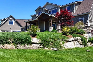 Design ideas for a mid-sized traditional full sun front yard brick landscaping in Boston for summer.