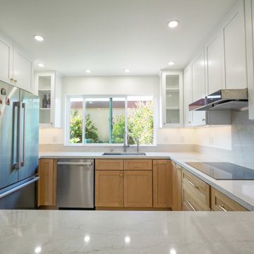 Modern White and Natural Oak Kitchen with Brass Hardware and Quartz Backsplash