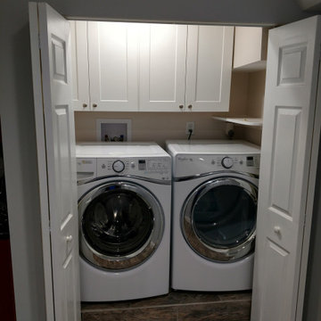 Basement remodel with hidden audio theater area and wet bar