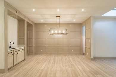 Mid-sized minimalist porcelain tile and brown floor great room photo in Houston with gray walls and no fireplace