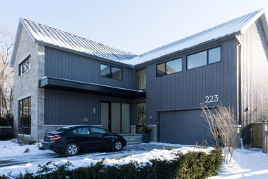 Large contemporary two-storey grey exterior in Toronto with mixed siding and a gable roof.