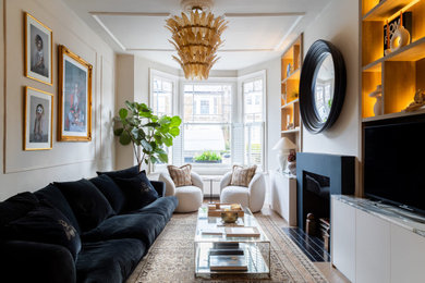 Inspiration for a traditional living room in London with beige walls, medium hardwood flooring, a standard fireplace, a freestanding tv and brown floors.