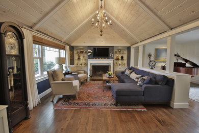 Inspiration for a large timeless formal and open concept medium tone wood floor and brown floor living room remodel in Boston with blue walls, a standard fireplace, a stone fireplace and a wall-mounted tv