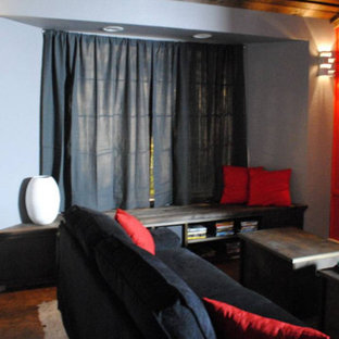 Photo of a medium sized modern enclosed home cinema in Sacramento with red walls, cork flooring and a projector screen.