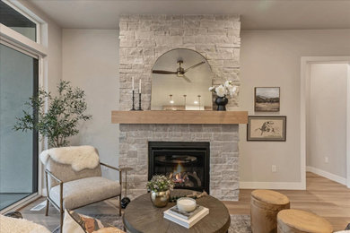 Living room - mid-sized beige floor living room idea in Salt Lake City with a standard fireplace and a stone fireplace