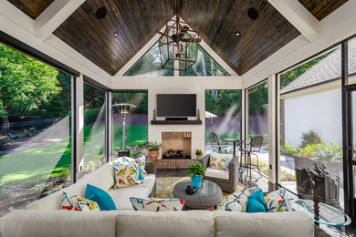 Large trendy porch photo in Other with a fireplace and a roof extension