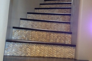 Inspiration for a mid-sized modern wooden curved staircase remodel in Phoenix with tile risers