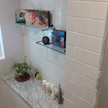 Classic look of a Carrara marble countertop and subway tile in an alcove area in